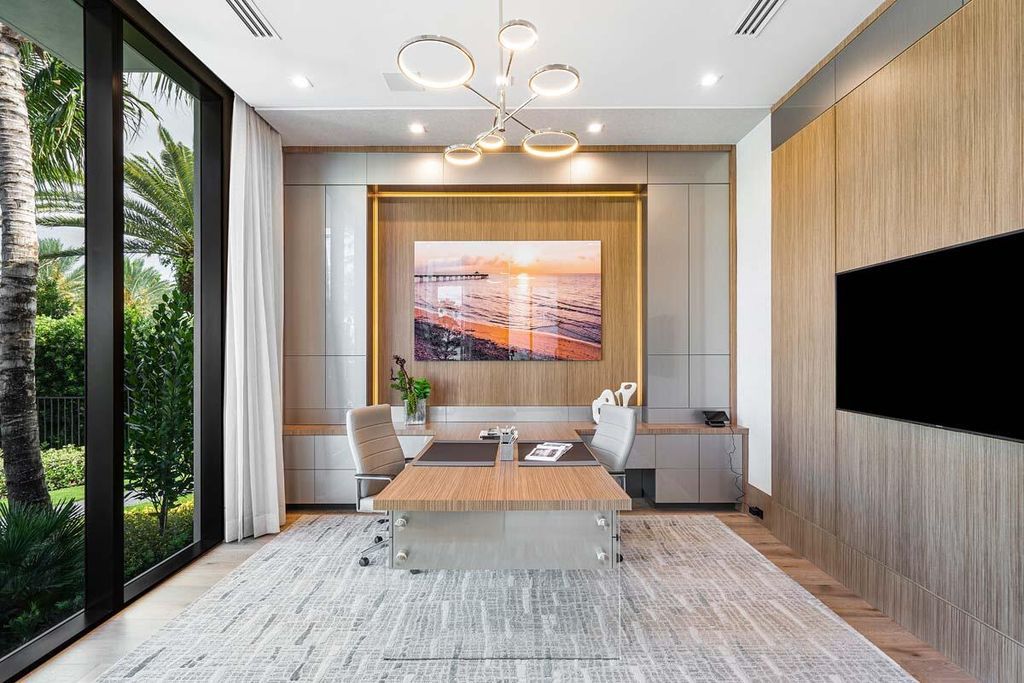 This prestigious Signature Estate within the Royal Palm Yacht & Country Club offers breathtaking views of lush golf course fairways.