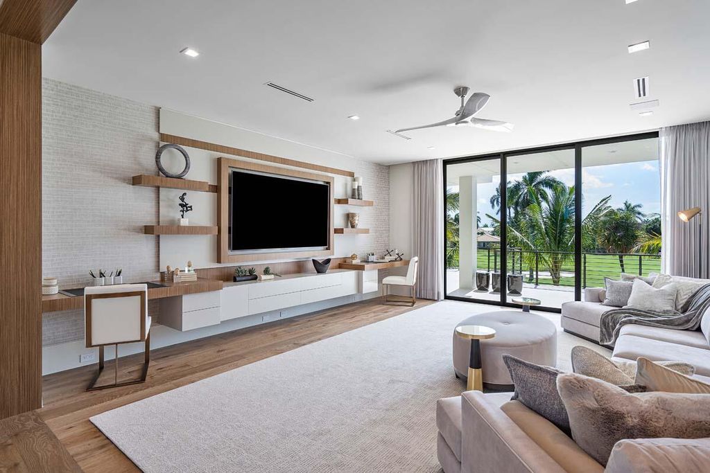 This prestigious Signature Estate within the Royal Palm Yacht & Country Club offers breathtaking views of lush golf course fairways.
