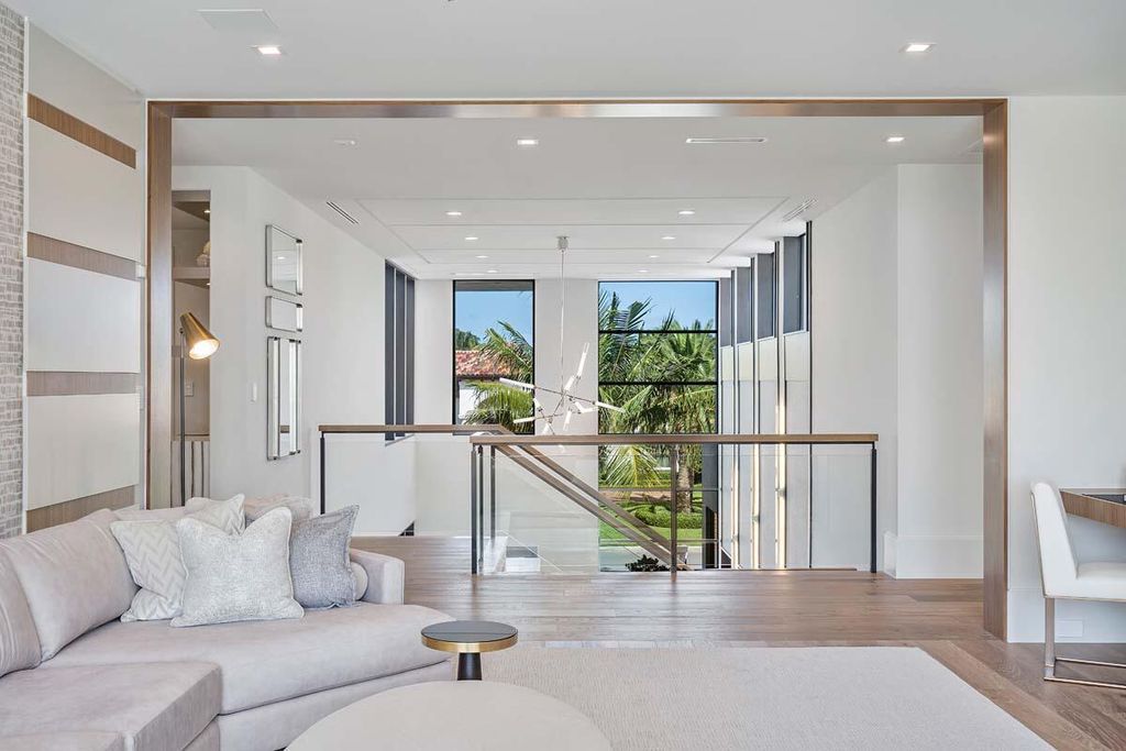 This prestigious Signature Estate within the Royal Palm Yacht & Country Club offers breathtaking views of lush golf course fairways.