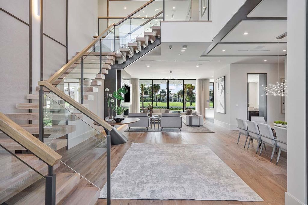 This prestigious Signature Estate within the Royal Palm Yacht & Country Club offers breathtaking views of lush golf course fairways.