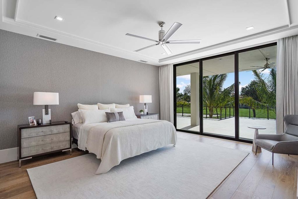This prestigious Signature Estate within the Royal Palm Yacht & Country Club offers breathtaking views of lush golf course fairways.