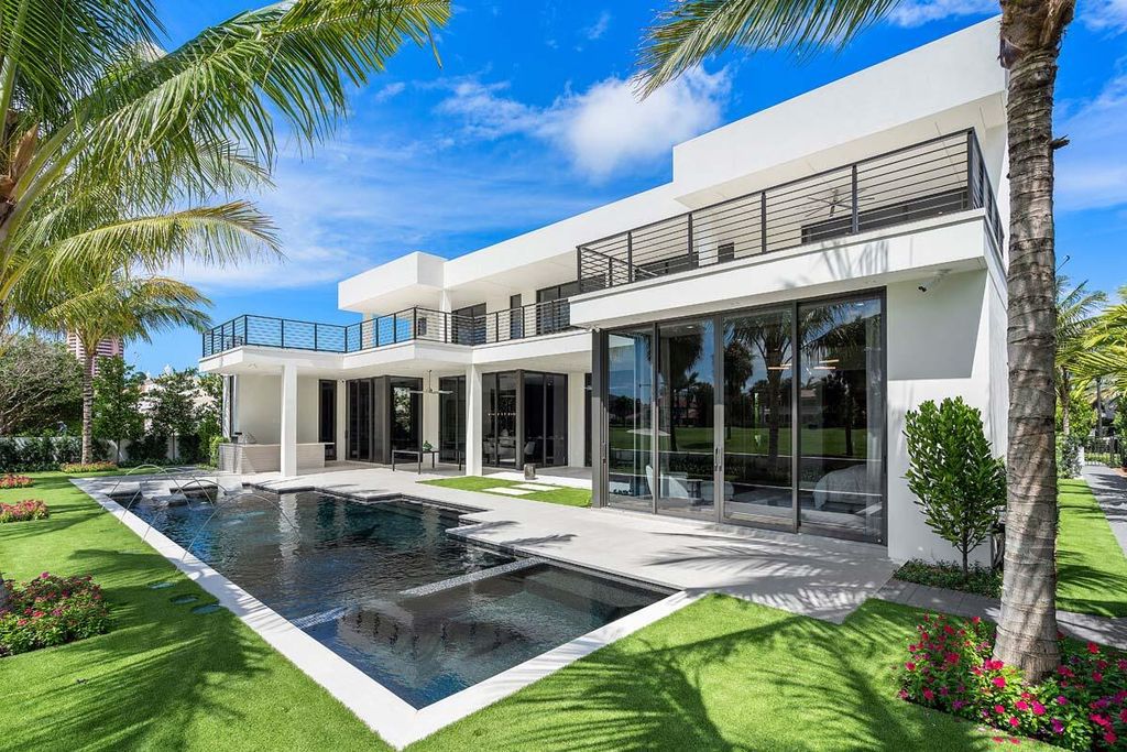 This prestigious Signature Estate within the Royal Palm Yacht & Country Club offers breathtaking views of lush golf course fairways.