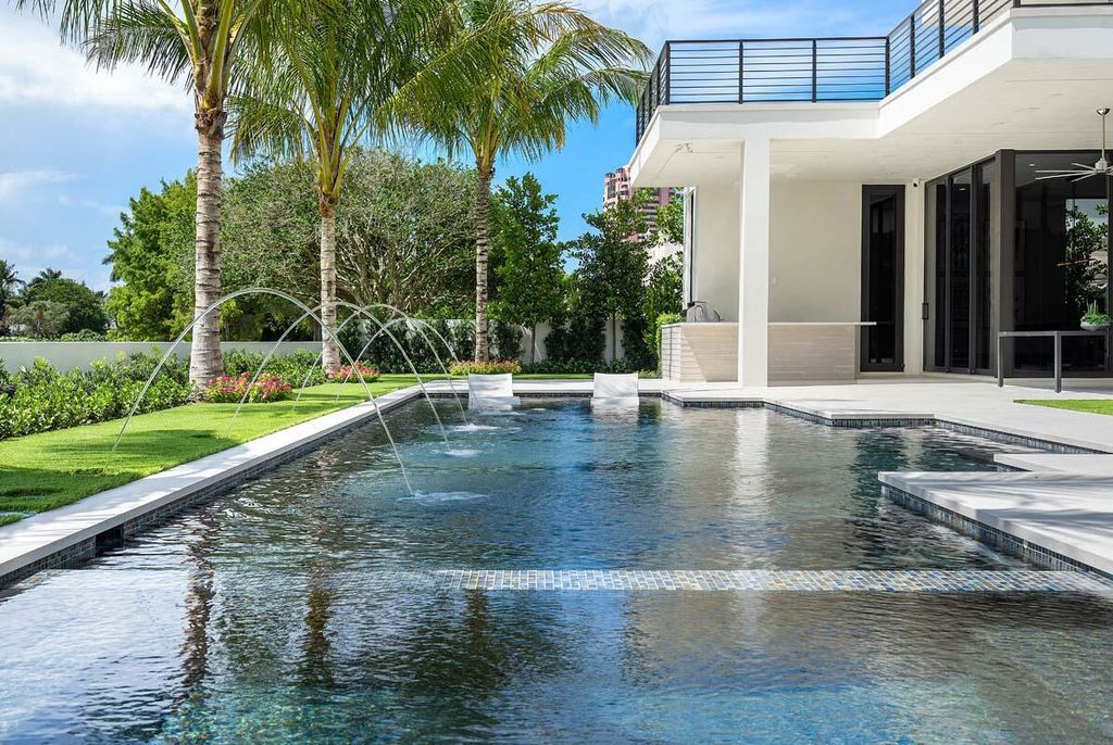 This prestigious Signature Estate within the Royal Palm Yacht & Country Club offers breathtaking views of lush golf course fairways.