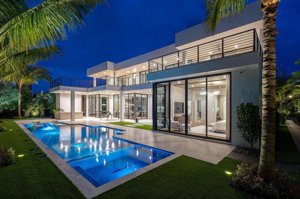 This prestigious Signature Estate within the Royal Palm Yacht & Country Club offers breathtaking views of lush golf course fairways.
