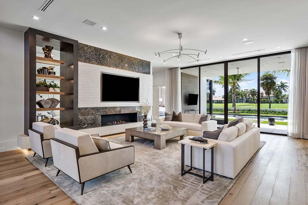 This prestigious Signature Estate within the Royal Palm Yacht & Country Club offers breathtaking views of lush golf course fairways.