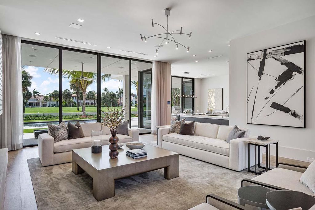 This prestigious Signature Estate within the Royal Palm Yacht & Country Club offers breathtaking views of lush golf course fairways.