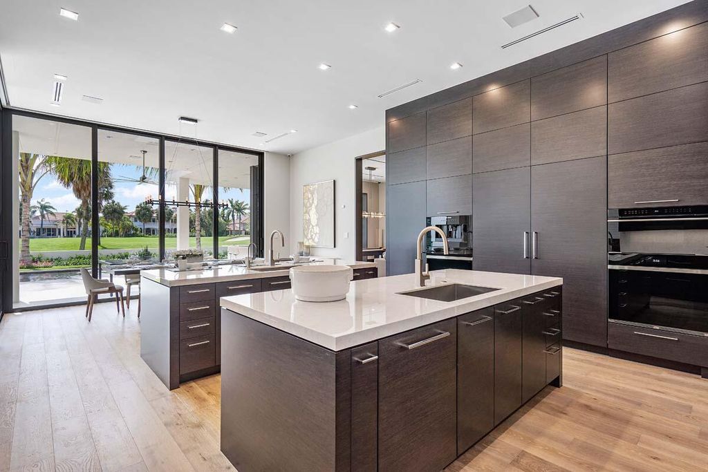 This prestigious Signature Estate within the Royal Palm Yacht & Country Club offers breathtaking views of lush golf course fairways.