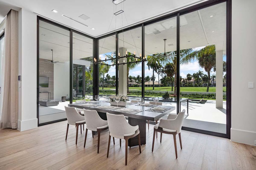 This prestigious Signature Estate within the Royal Palm Yacht & Country Club offers breathtaking views of lush golf course fairways.