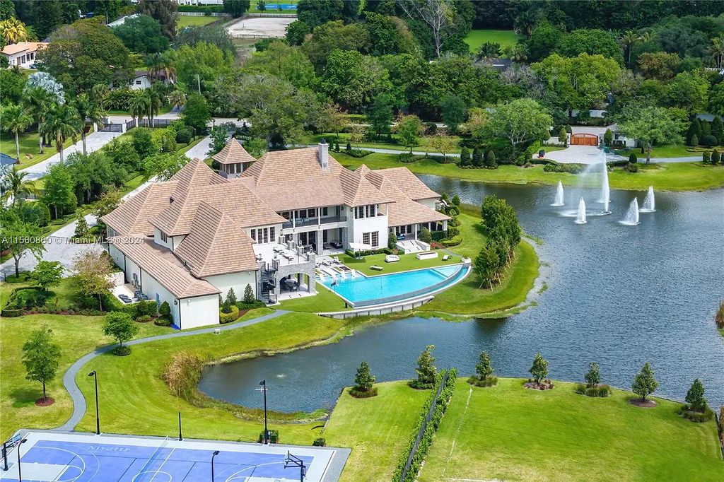 Indulge in the pinnacle of luxury with this custom French Country style mansion in Southwest Ranches, boasting over 15,000 square feet of meticulously crafted living space.
