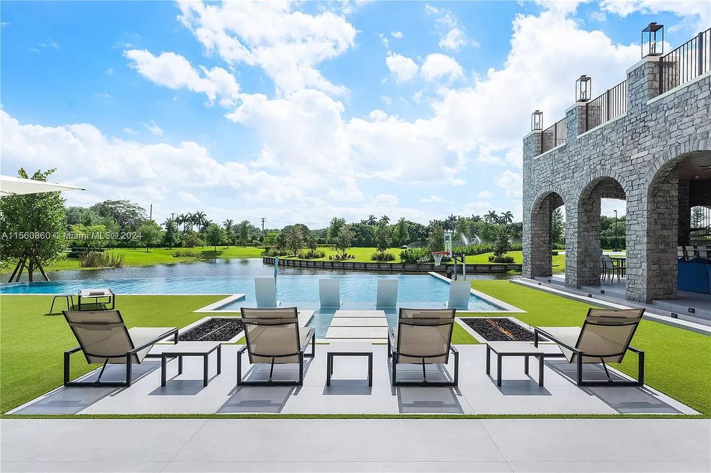 Indulge in the pinnacle of luxury with this custom French Country style mansion in Southwest Ranches, boasting over 15,000 square feet of meticulously crafted living space.