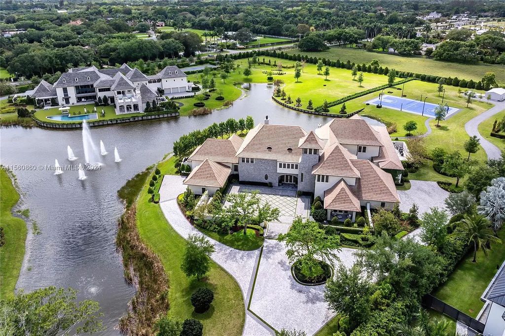 Indulge in the pinnacle of luxury with this custom French Country style mansion in Southwest Ranches, boasting over 15,000 square feet of meticulously crafted living space.