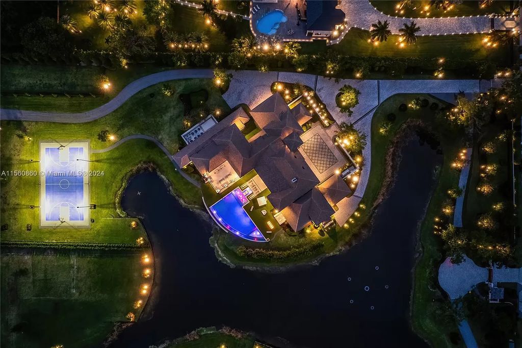 Indulge in the pinnacle of luxury with this custom French Country style mansion in Southwest Ranches, boasting over 15,000 square feet of meticulously crafted living space.