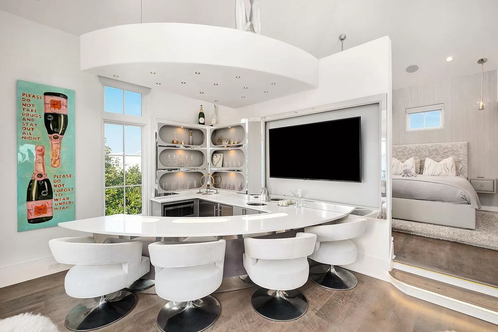This meticulously crafted masterpiece boasts a seamless blend of indoor and outdoor spaces, offering unparalleled views of the azure waters.