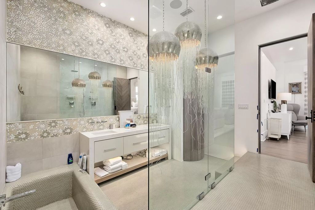 This meticulously crafted masterpiece boasts a seamless blend of indoor and outdoor spaces, offering unparalleled views of the azure waters.