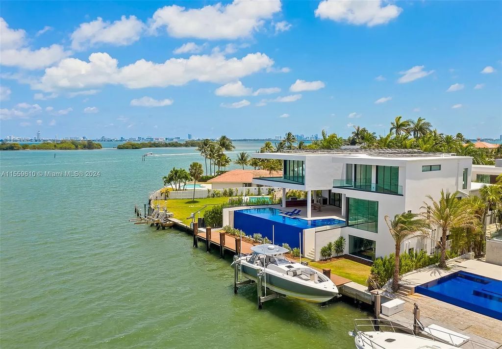 Welcome to 1133 Belle Meade Island Dr, a breathtaking Bay/Canal Contemporary Residence in the heart of Miami. This New Construction marvel boasts 100+ ft on deep water, showcasing Travertine exterior walls and ultra-luxury finishes throughout its 12,200 SF under A/C.