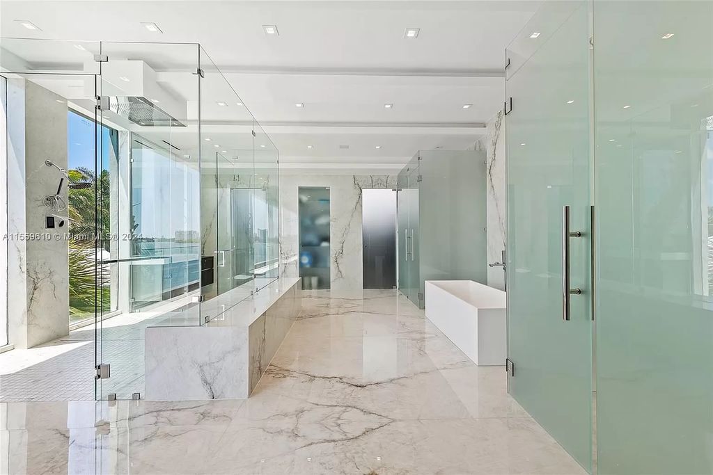 Welcome to 1133 Belle Meade Island Dr, a breathtaking Bay/Canal Contemporary Residence in the heart of Miami. This New Construction marvel boasts 100+ ft on deep water, showcasing Travertine exterior walls and ultra-luxury finishes throughout its 12,200 SF under A/C.