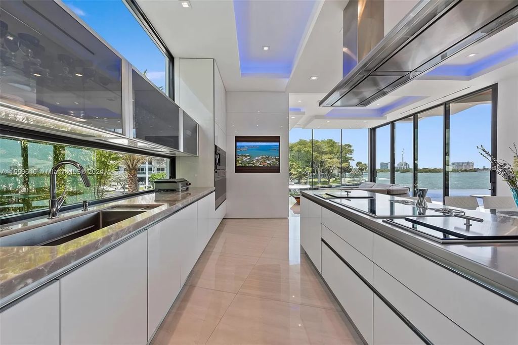 Welcome to 1133 Belle Meade Island Dr, a breathtaking Bay/Canal Contemporary Residence in the heart of Miami. This New Construction marvel boasts 100+ ft on deep water, showcasing Travertine exterior walls and ultra-luxury finishes throughout its 12,200 SF under A/C.