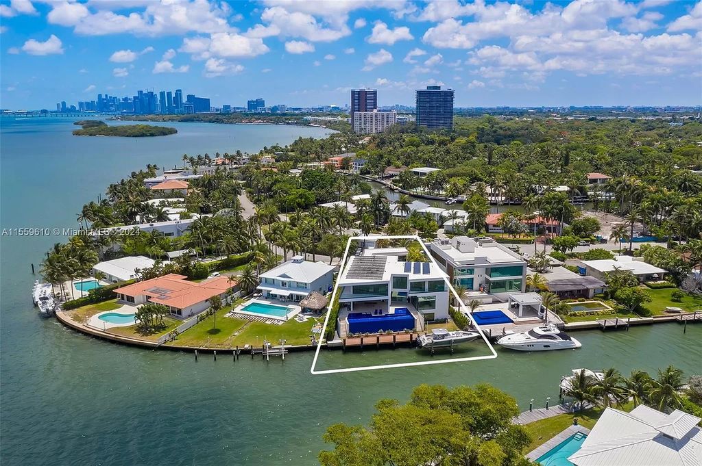 Welcome to 1133 Belle Meade Island Dr, a breathtaking Bay/Canal Contemporary Residence in the heart of Miami. This New Construction marvel boasts 100+ ft on deep water, showcasing Travertine exterior walls and ultra-luxury finishes throughout its 12,200 SF under A/C.