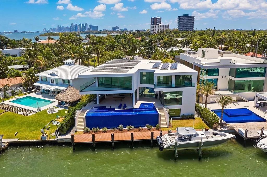 Welcome to 1133 Belle Meade Island Dr, a breathtaking Bay/Canal Contemporary Residence in the heart of Miami. This New Construction marvel boasts 100+ ft on deep water, showcasing Travertine exterior walls and ultra-luxury finishes throughout its 12,200 SF under A/C.