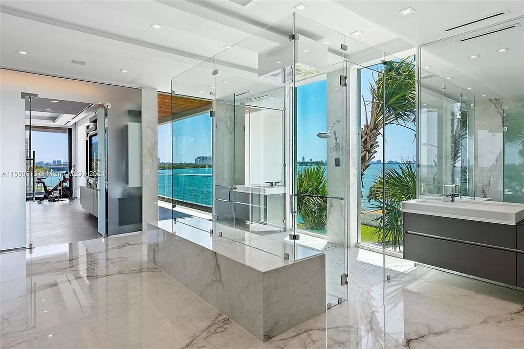 Welcome to 1133 Belle Meade Island Dr, a breathtaking Bay/Canal Contemporary Residence in the heart of Miami. This New Construction marvel boasts 100+ ft on deep water, showcasing Travertine exterior walls and ultra-luxury finishes throughout its 12,200 SF under A/C.