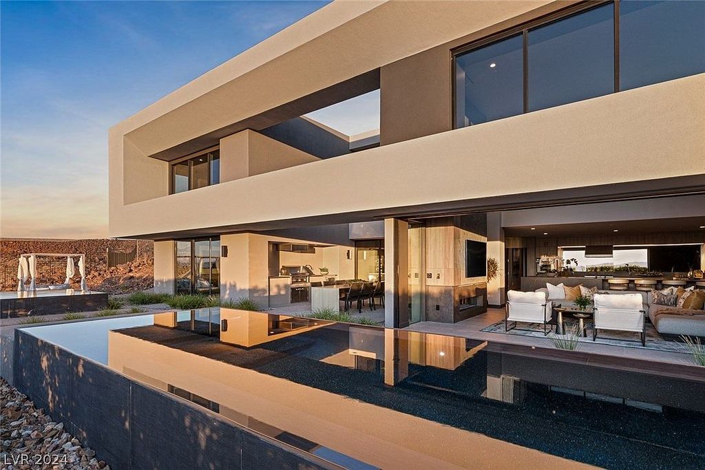 709 Dragon Peak Drive Home in Henderson, Nevada. Discover the thrill of living at Drift, an extraordinary residence from The Luminary Collection, fully furnished by Atelier Blue Heron Interiors and ready for immediate move-in. Nestled within the exclusive guard-gated enclave of MacDonald Highlands, Drift offers an enviable address on Dragon Peak Drive, often hailed as the Hollywood Hills of Las Vegas.