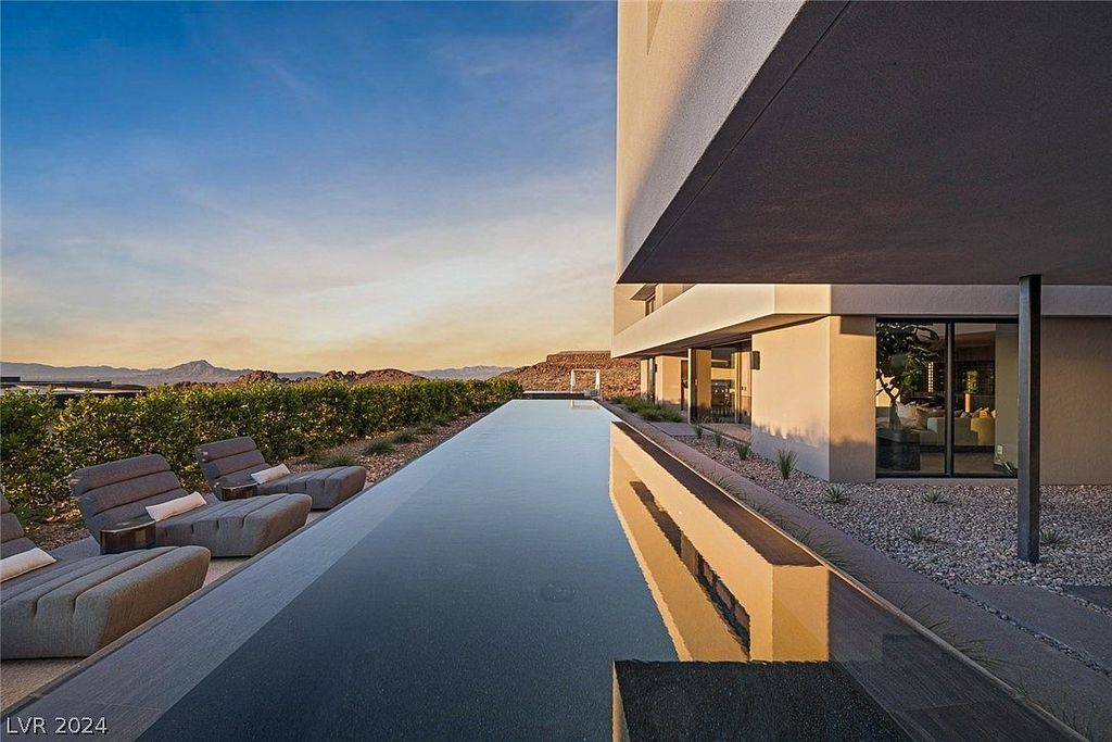 709 Dragon Peak Drive Home in Henderson, Nevada. Discover the thrill of living at Drift, an extraordinary residence from The Luminary Collection, fully furnished by Atelier Blue Heron Interiors and ready for immediate move-in. Nestled within the exclusive guard-gated enclave of MacDonald Highlands, Drift offers an enviable address on Dragon Peak Drive, often hailed as the Hollywood Hills of Las Vegas.