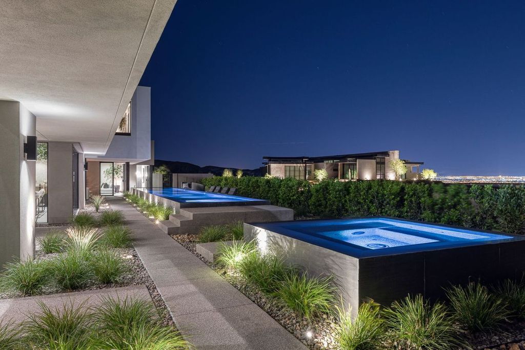 709 Dragon Peak Drive Home in Henderson, Nevada. Discover the thrill of living at Drift, an extraordinary residence from The Luminary Collection, fully furnished by Atelier Blue Heron Interiors and ready for immediate move-in. Nestled within the exclusive guard-gated enclave of MacDonald Highlands, Drift offers an enviable address on Dragon Peak Drive, often hailed as the Hollywood Hills of Las Vegas.