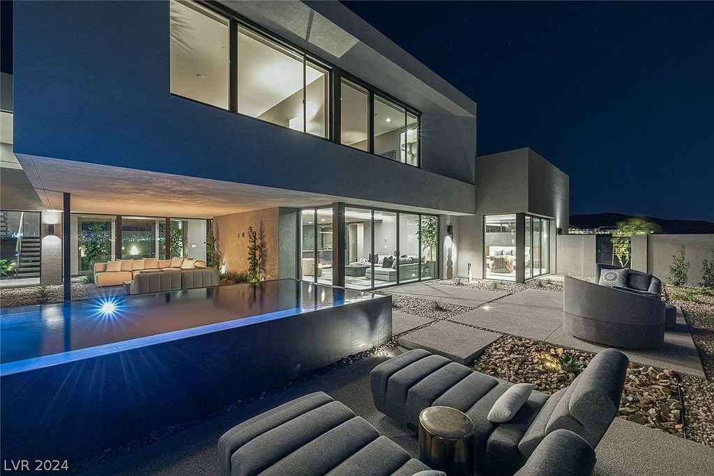 709 Dragon Peak Drive Home in Henderson, Nevada. Discover the thrill of living at Drift, an extraordinary residence from The Luminary Collection, fully furnished by Atelier Blue Heron Interiors and ready for immediate move-in. Nestled within the exclusive guard-gated enclave of MacDonald Highlands, Drift offers an enviable address on Dragon Peak Drive, often hailed as the Hollywood Hills of Las Vegas.