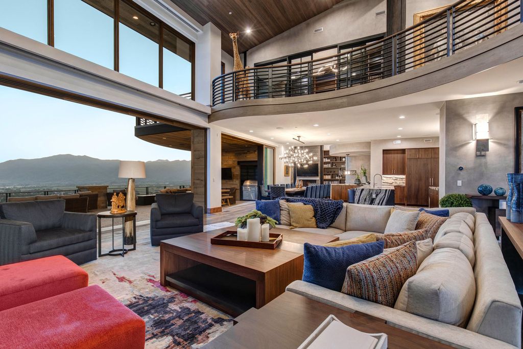 831 N Explorer Peak Drive Home in Heber, Utah. Perched atop the highest ridge within the exclusive confines of Red Ledges, this estate offers unparalleled vistas of the Mountain West. Crafted by renowned architect Michael Upwall, this residence redefines mountain modern living. 