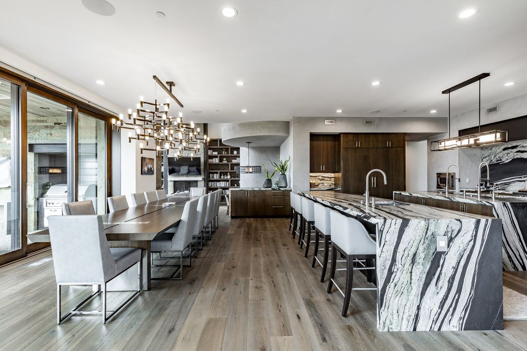 831 N Explorer Peak Drive Home in Heber, Utah. Perched atop the highest ridge within the exclusive confines of Red Ledges, this estate offers unparalleled vistas of the Mountain West. Crafted by renowned architect Michael Upwall, this residence redefines mountain modern living. 