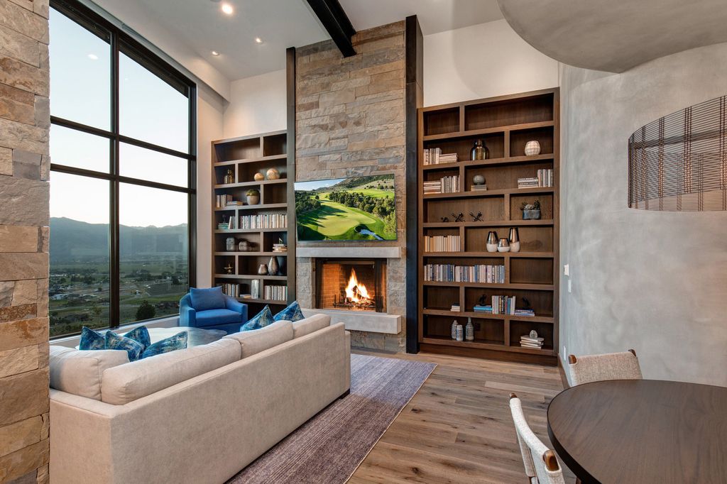 831 N Explorer Peak Drive Home in Heber, Utah. Perched atop the highest ridge within the exclusive confines of Red Ledges, this estate offers unparalleled vistas of the Mountain West. Crafted by renowned architect Michael Upwall, this residence redefines mountain modern living. 
