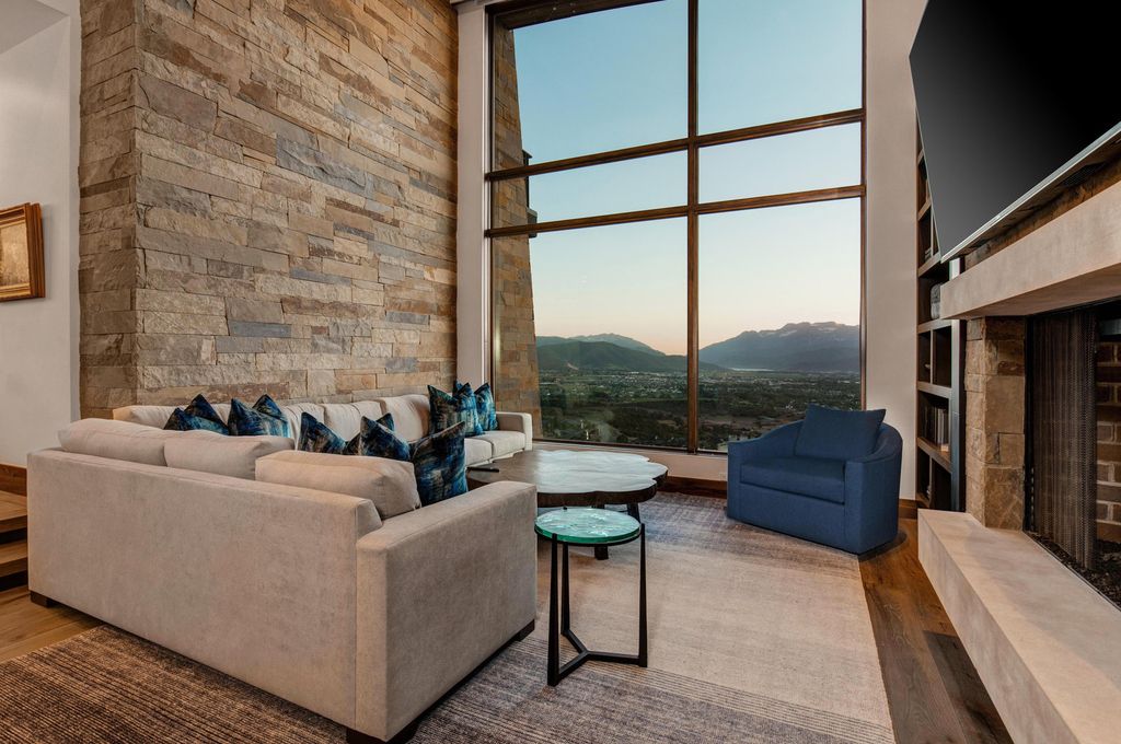 831 N Explorer Peak Drive Home in Heber, Utah. Perched atop the highest ridge within the exclusive confines of Red Ledges, this estate offers unparalleled vistas of the Mountain West. Crafted by renowned architect Michael Upwall, this residence redefines mountain modern living. 