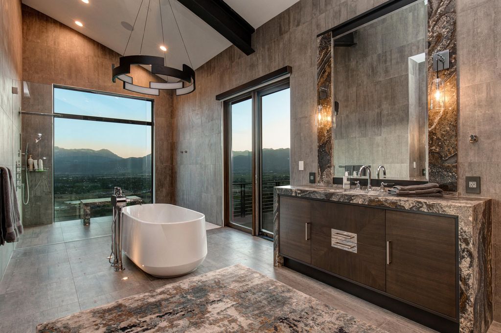 831 N Explorer Peak Drive Home in Heber, Utah. Perched atop the highest ridge within the exclusive confines of Red Ledges, this estate offers unparalleled vistas of the Mountain West. Crafted by renowned architect Michael Upwall, this residence redefines mountain modern living. 