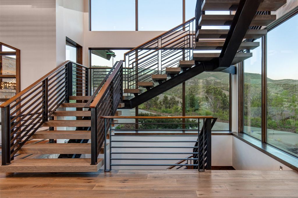 831 N Explorer Peak Drive Home in Heber, Utah. Perched atop the highest ridge within the exclusive confines of Red Ledges, this estate offers unparalleled vistas of the Mountain West. Crafted by renowned architect Michael Upwall, this residence redefines mountain modern living. 
