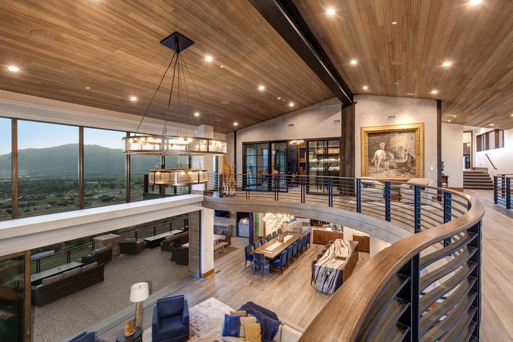 831 N Explorer Peak Drive Home in Heber, Utah. Perched atop the highest ridge within the exclusive confines of Red Ledges, this estate offers unparalleled vistas of the Mountain West. Crafted by renowned architect Michael Upwall, this residence redefines mountain modern living. 