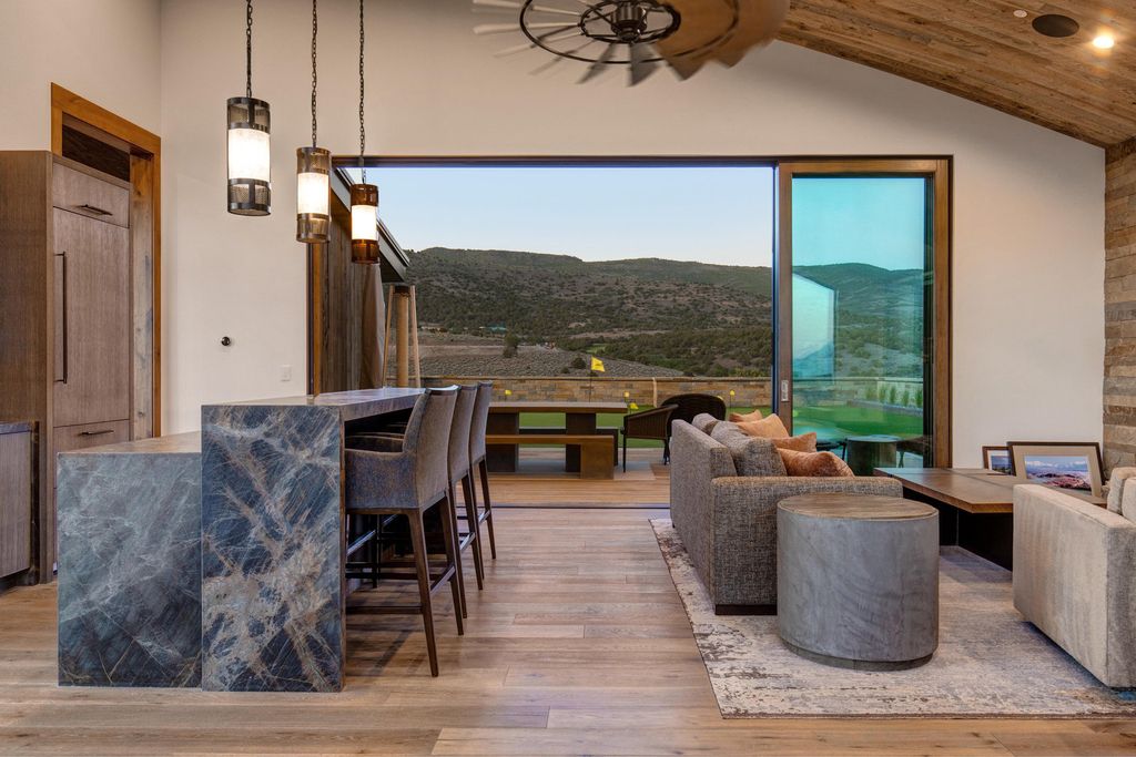 831 N Explorer Peak Drive Home in Heber, Utah. Perched atop the highest ridge within the exclusive confines of Red Ledges, this estate offers unparalleled vistas of the Mountain West. Crafted by renowned architect Michael Upwall, this residence redefines mountain modern living. 