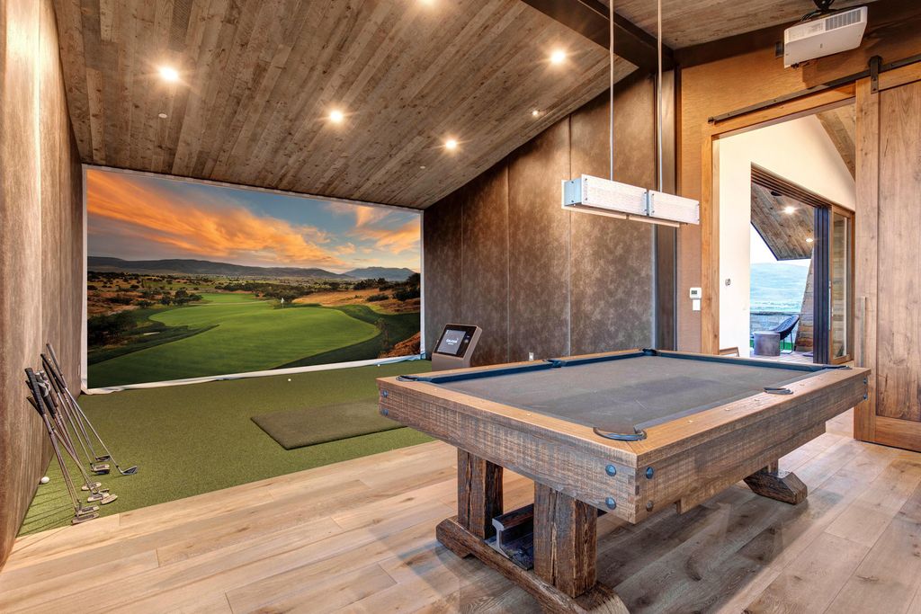 831 N Explorer Peak Drive Home in Heber, Utah. Perched atop the highest ridge within the exclusive confines of Red Ledges, this estate offers unparalleled vistas of the Mountain West. Crafted by renowned architect Michael Upwall, this residence redefines mountain modern living. 