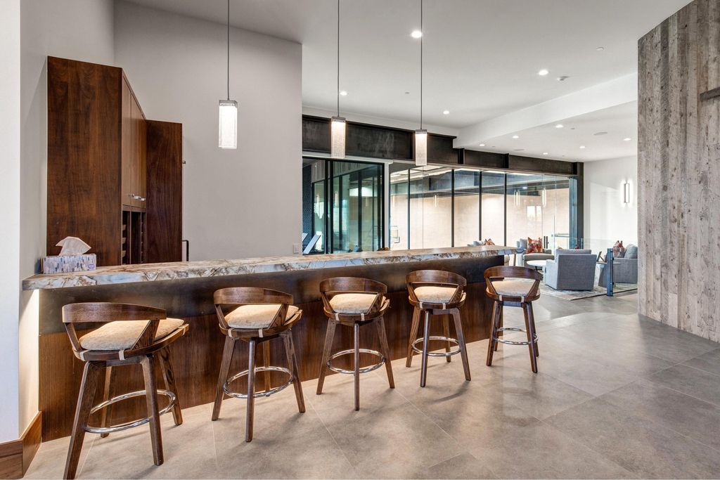 831 N Explorer Peak Drive Home in Heber, Utah. Perched atop the highest ridge within the exclusive confines of Red Ledges, this estate offers unparalleled vistas of the Mountain West. Crafted by renowned architect Michael Upwall, this residence redefines mountain modern living. 