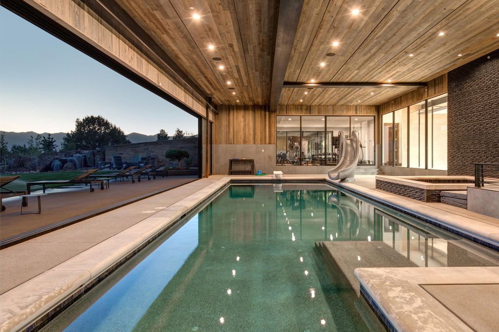 831 N Explorer Peak Drive Home in Heber, Utah. Perched atop the highest ridge within the exclusive confines of Red Ledges, this estate offers unparalleled vistas of the Mountain West. Crafted by renowned architect Michael Upwall, this residence redefines mountain modern living. 