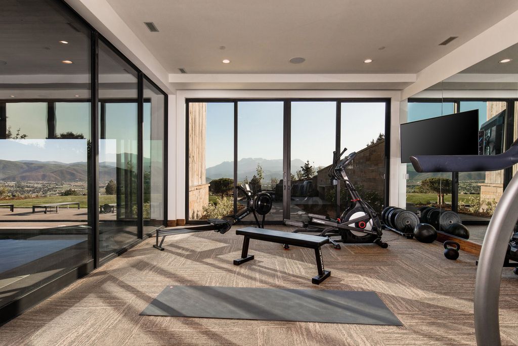 831 N Explorer Peak Drive Home in Heber, Utah. Perched atop the highest ridge within the exclusive confines of Red Ledges, this estate offers unparalleled vistas of the Mountain West. Crafted by renowned architect Michael Upwall, this residence redefines mountain modern living. 