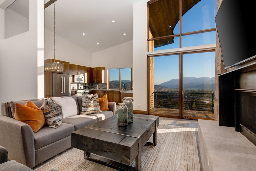 831 N Explorer Peak Drive Home in Heber, Utah. Perched atop the highest ridge within the exclusive confines of Red Ledges, this estate offers unparalleled vistas of the Mountain West. Crafted by renowned architect Michael Upwall, this residence redefines mountain modern living. 