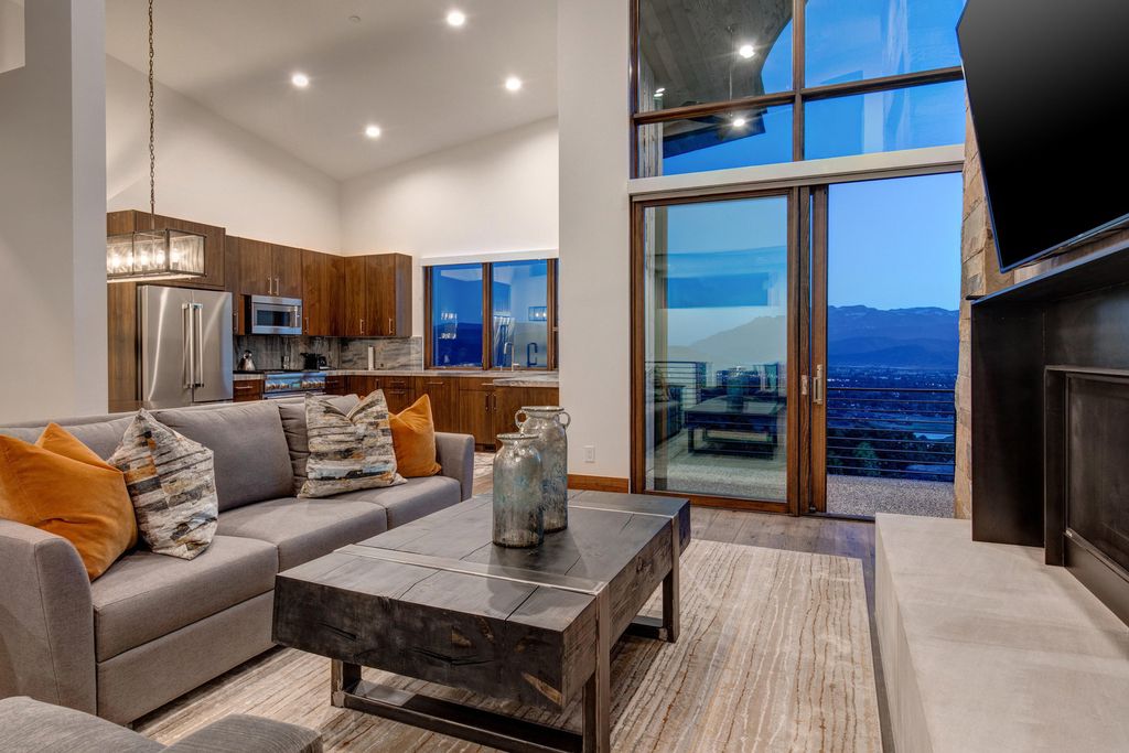 831 N Explorer Peak Drive Home in Heber, Utah. Perched atop the highest ridge within the exclusive confines of Red Ledges, this estate offers unparalleled vistas of the Mountain West. Crafted by renowned architect Michael Upwall, this residence redefines mountain modern living. 