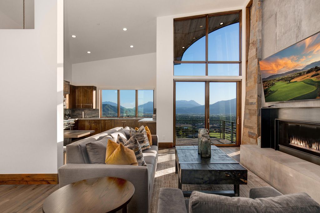 831 N Explorer Peak Drive Home in Heber, Utah. Perched atop the highest ridge within the exclusive confines of Red Ledges, this estate offers unparalleled vistas of the Mountain West. Crafted by renowned architect Michael Upwall, this residence redefines mountain modern living. 