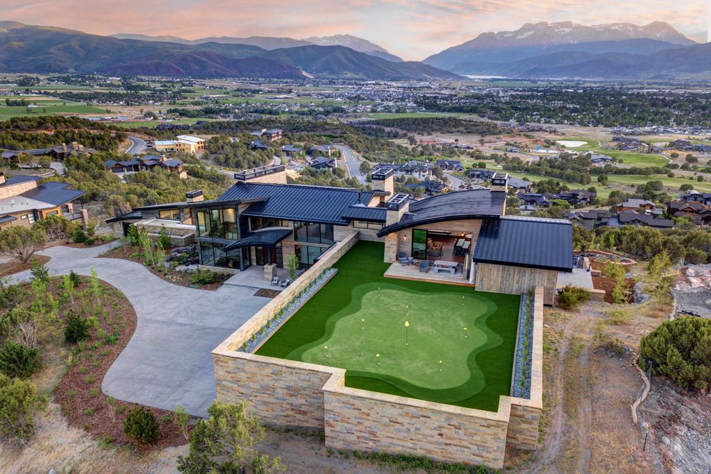 831 N Explorer Peak Drive Home in Heber, Utah. Perched atop the highest ridge within the exclusive confines of Red Ledges, this estate offers unparalleled vistas of the Mountain West. Crafted by renowned architect Michael Upwall, this residence redefines mountain modern living. 