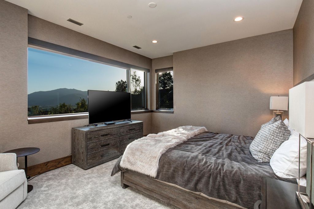 831 N Explorer Peak Drive Home in Heber, Utah. Perched atop the highest ridge within the exclusive confines of Red Ledges, this estate offers unparalleled vistas of the Mountain West. Crafted by renowned architect Michael Upwall, this residence redefines mountain modern living. 