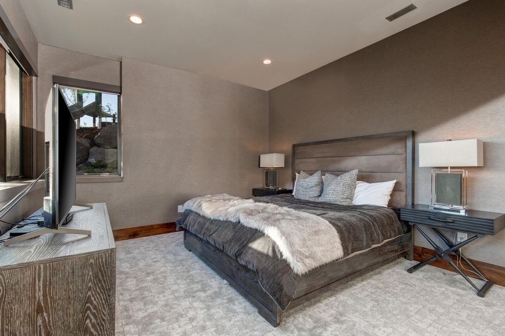 831 N Explorer Peak Drive Home in Heber, Utah. Perched atop the highest ridge within the exclusive confines of Red Ledges, this estate offers unparalleled vistas of the Mountain West. Crafted by renowned architect Michael Upwall, this residence redefines mountain modern living. 