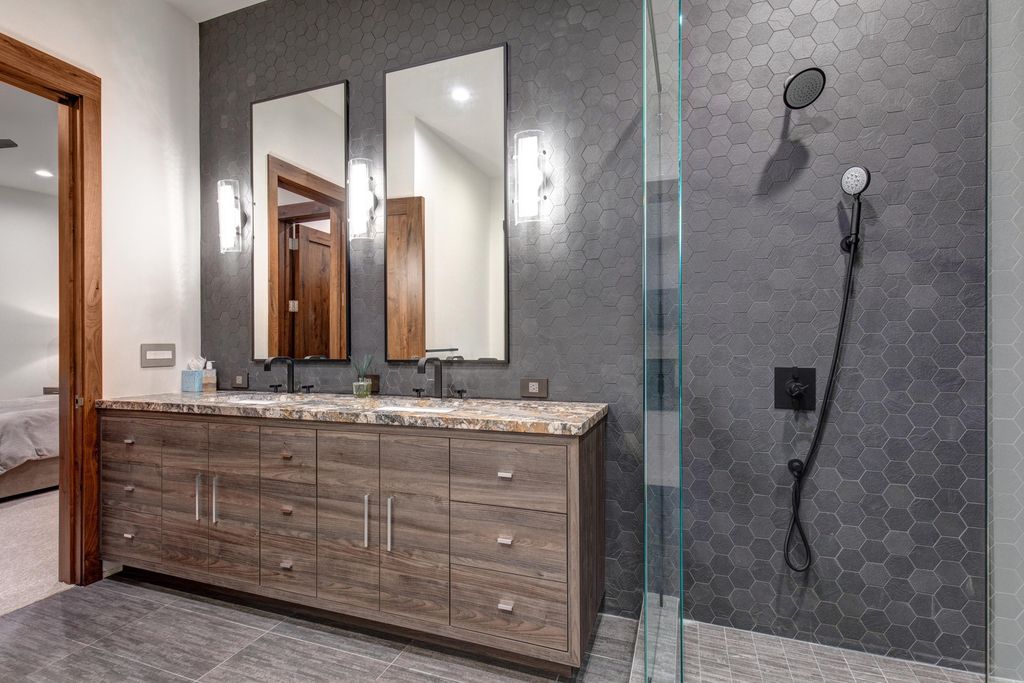 831 N Explorer Peak Drive Home in Heber, Utah. Perched atop the highest ridge within the exclusive confines of Red Ledges, this estate offers unparalleled vistas of the Mountain West. Crafted by renowned architect Michael Upwall, this residence redefines mountain modern living. 