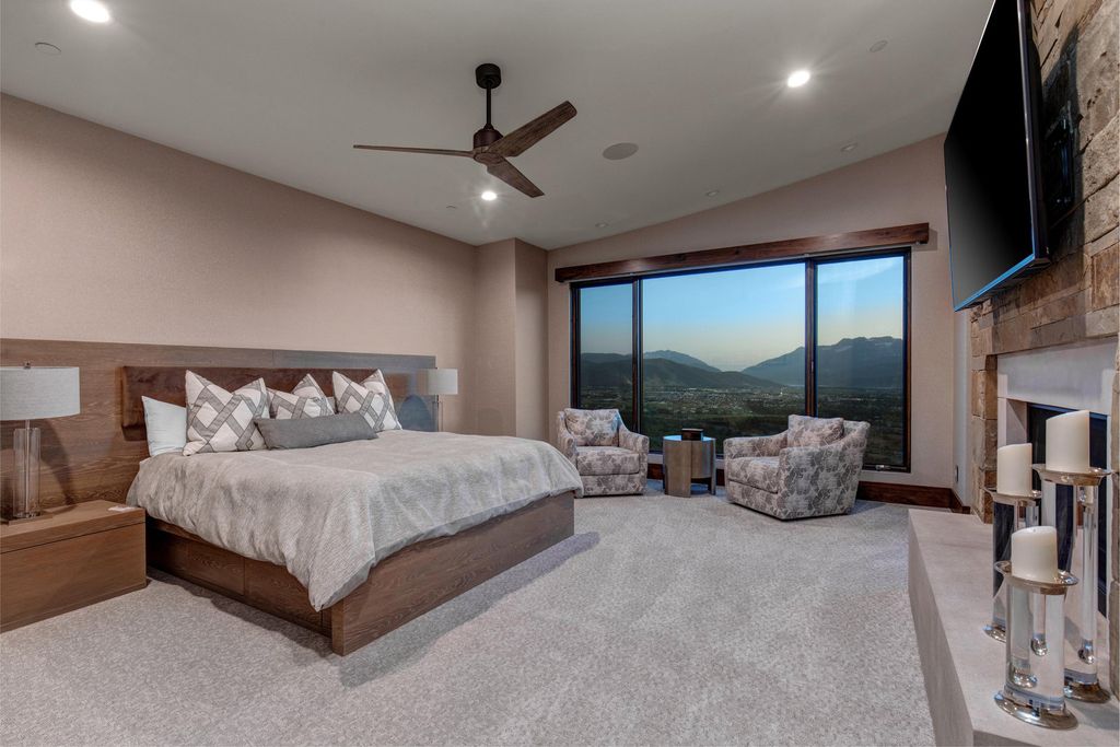 831 N Explorer Peak Drive Home in Heber, Utah. Perched atop the highest ridge within the exclusive confines of Red Ledges, this estate offers unparalleled vistas of the Mountain West. Crafted by renowned architect Michael Upwall, this residence redefines mountain modern living. 