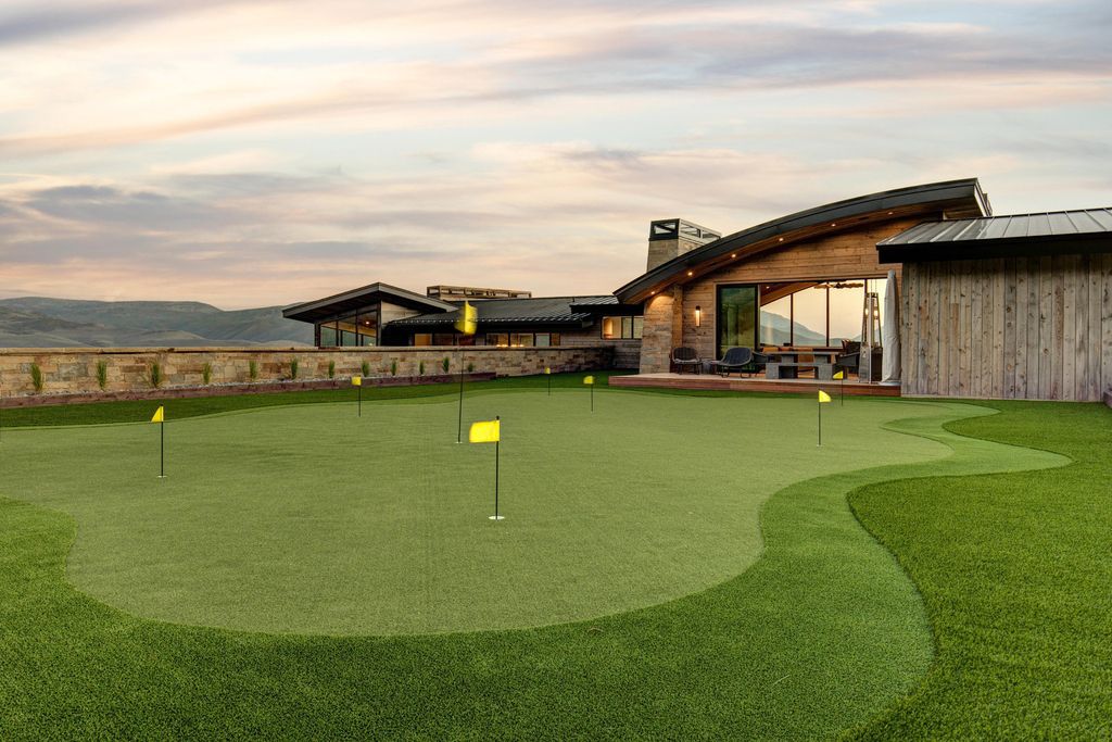 831 N Explorer Peak Drive Home in Heber, Utah. Perched atop the highest ridge within the exclusive confines of Red Ledges, this estate offers unparalleled vistas of the Mountain West. Crafted by renowned architect Michael Upwall, this residence redefines mountain modern living. 