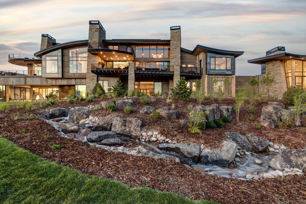 831 N Explorer Peak Drive Home in Heber, Utah. Perched atop the highest ridge within the exclusive confines of Red Ledges, this estate offers unparalleled vistas of the Mountain West. Crafted by renowned architect Michael Upwall, this residence redefines mountain modern living. 